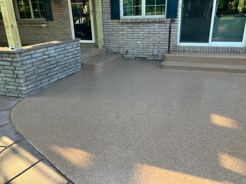Tan and brown flake epoxy coating on a backyard patio with steps