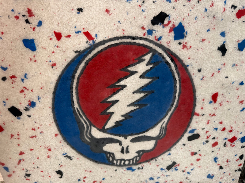 White flake epoxy floor with a custom Grateful Dead skull logo inlay