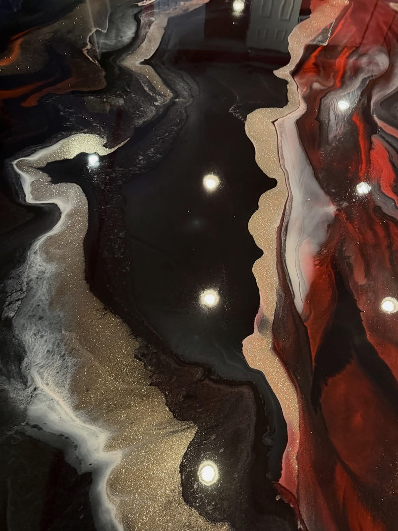 Close-up of black, gold and red marbled metallic epoxy floor