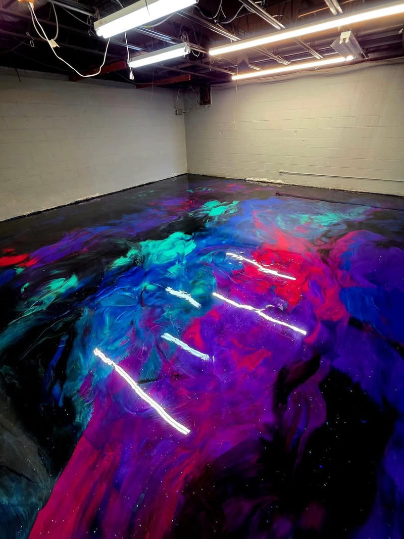Neon purple, blue, teal and red metallic epoxy floor in a warehouse