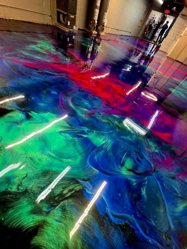 Vibrant green, blue, purple and red metallic epoxy floor in a commercial space