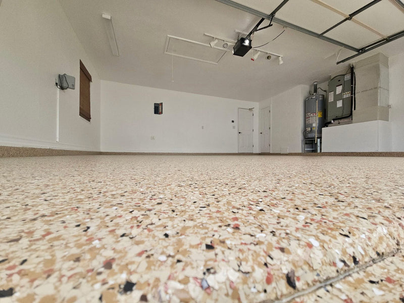 Tan flake epoxy garage floor shown from a low angle