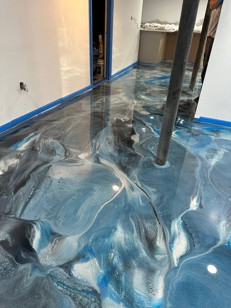 Blue and silver metallic epoxy floor during installation