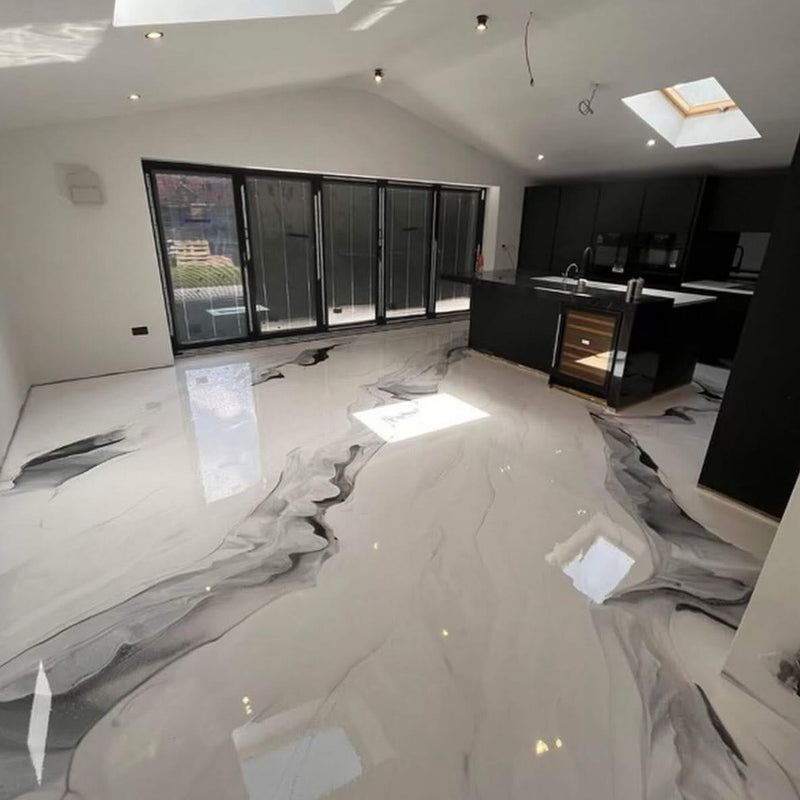 White and black marbled metallic epoxy floor in a modern kitchen with skylights