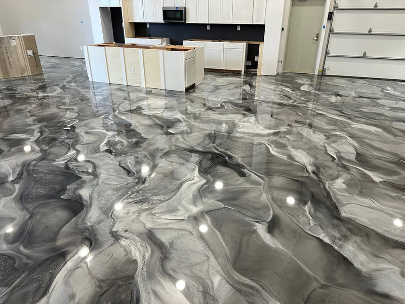 Gray and white swirled metallic epoxy floor in an open kitchen