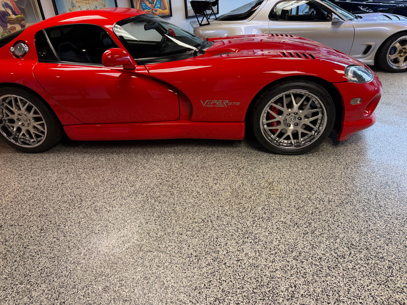 Gray and white flake epoxy showroom floor with a red Dodge Viper GTS